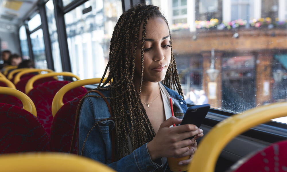 Women on bus looking at phone