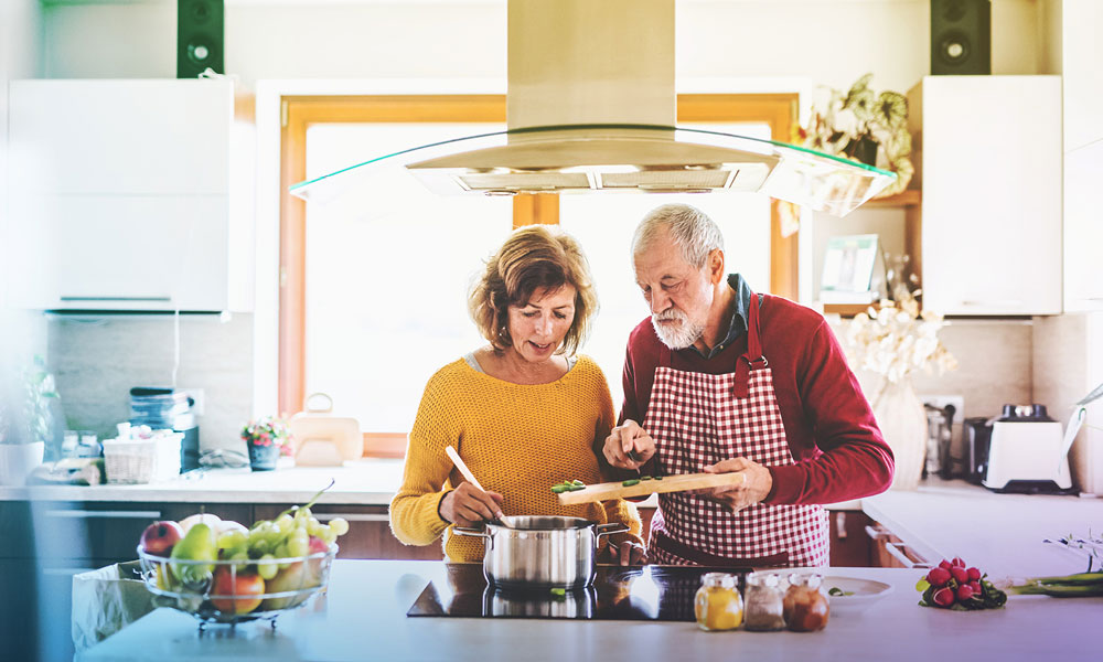 elderly couple making soup